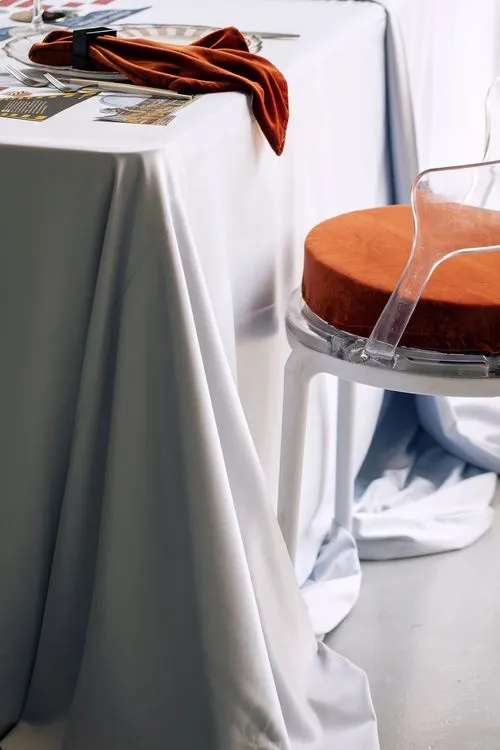 Table setting with orange accents at rectangular table