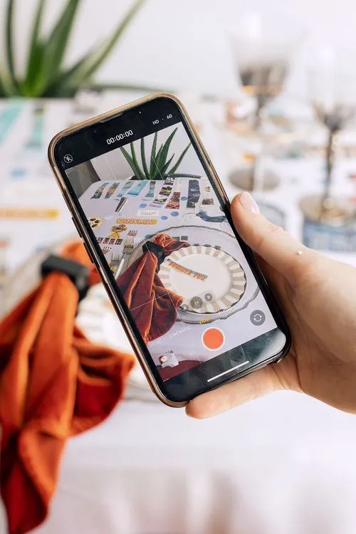 Table setting with orange accents at rectangular table