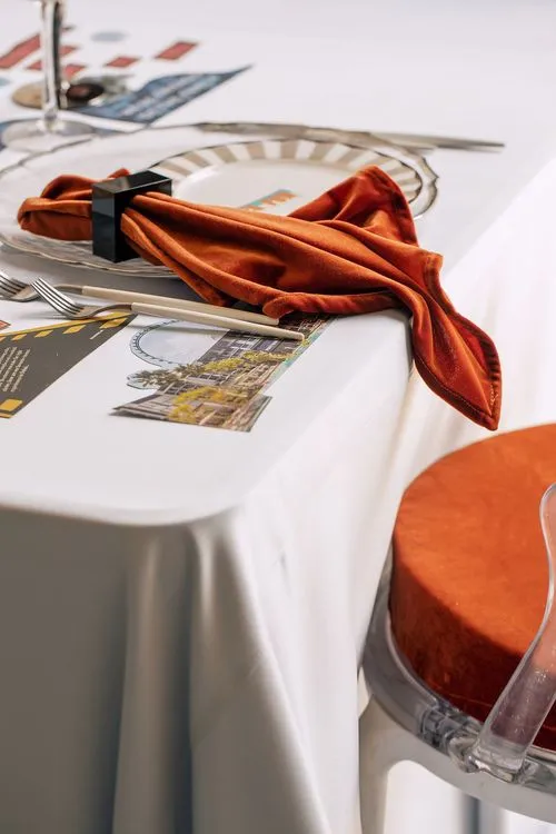 Table setting with orange accents at rectangular table