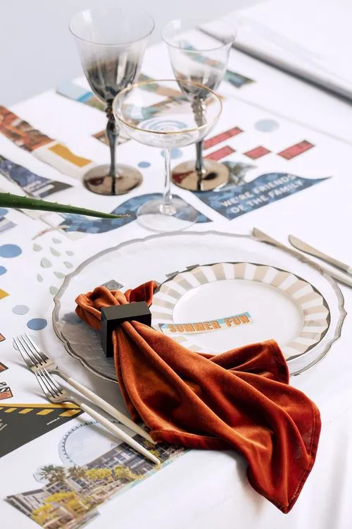 Table setting with orange accents at rectangular table