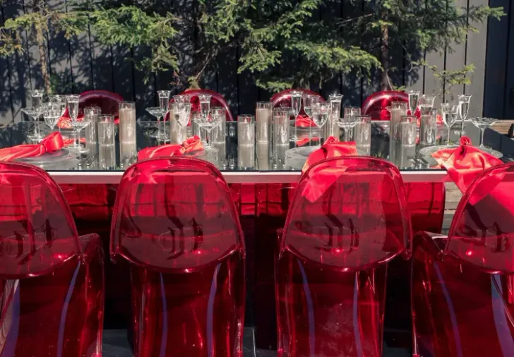 Translucent set with red accents on a white rectangular table