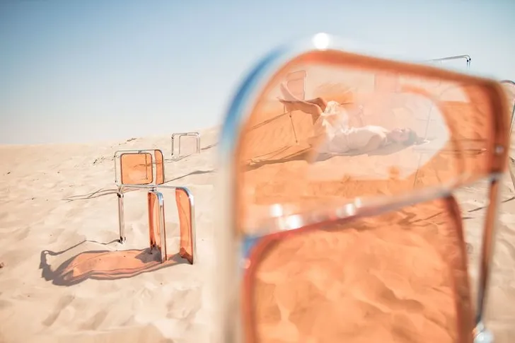 Transparent folding chairs desert