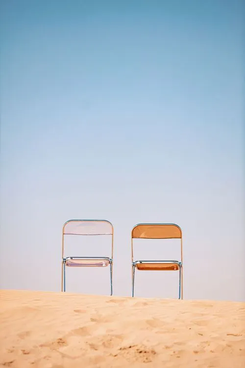 Transparent folding chairs desert