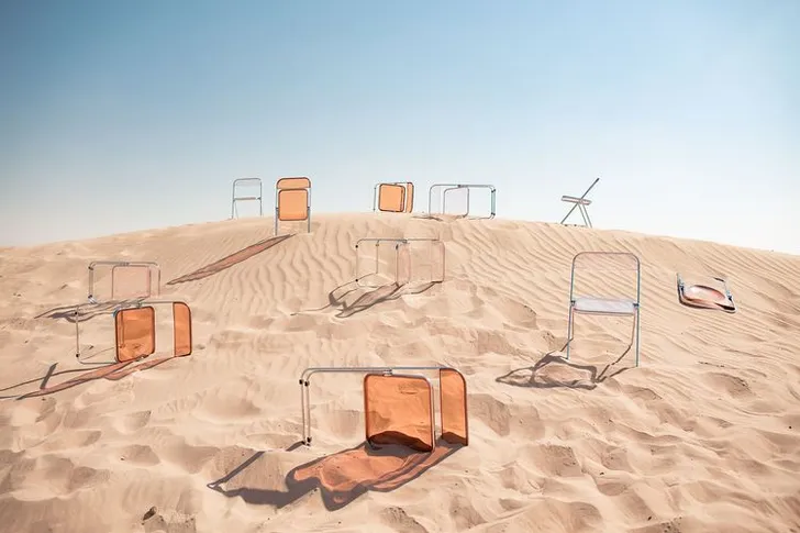 Transparent folding chairs desert
