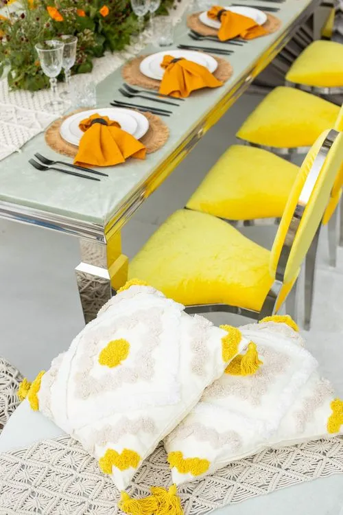 Yellow-orange table setting at rectangular table