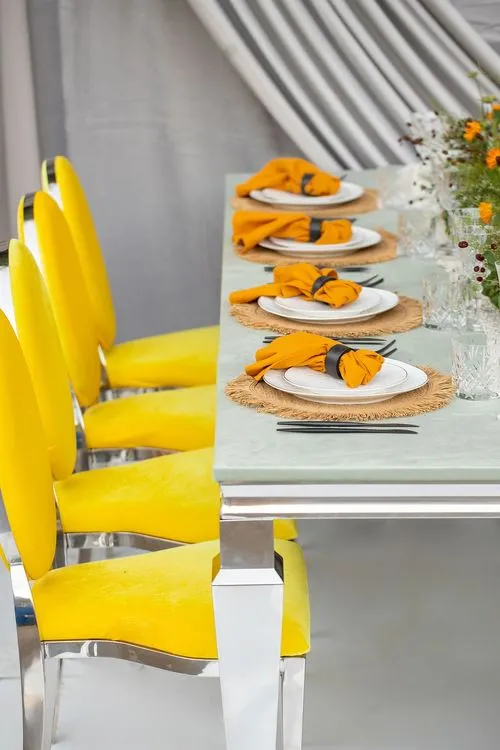Yellow-orange table setting at rectangular table